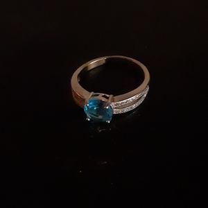 Silver toned ring with bright sky blue stone